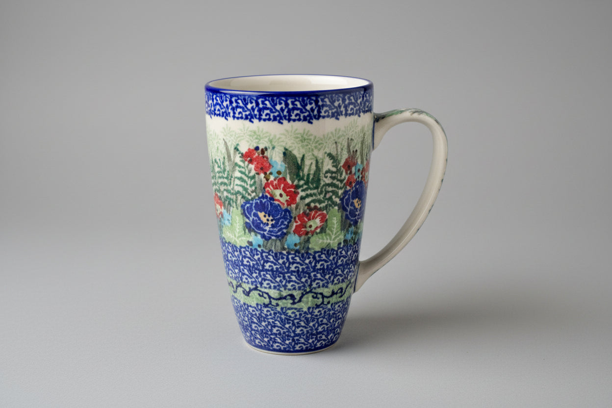 Decorative ceramic mug with floral patterns on a lace tablecloth