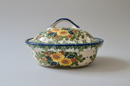 Decorative ceramic dish with sunflower pattern on a lace tablecloth
