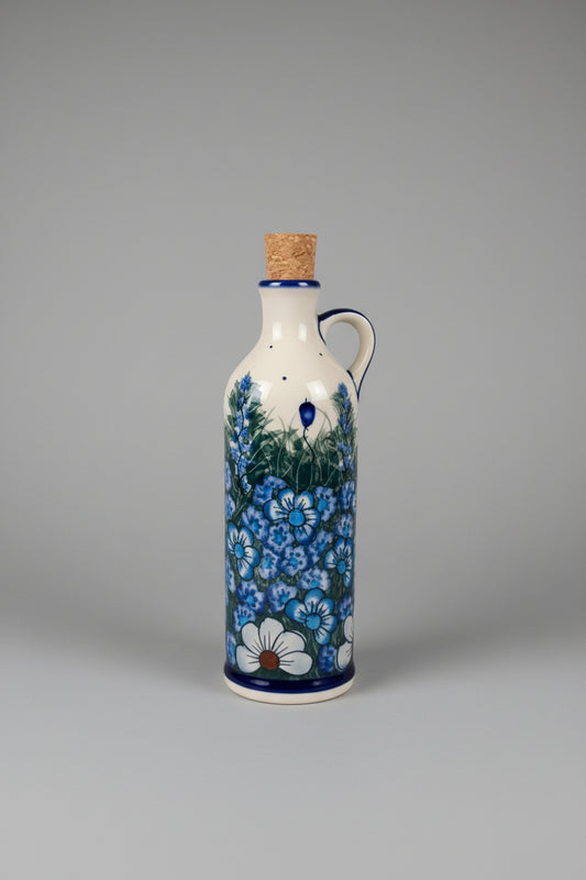 Decorative ceramic bottle with floral design on a textured surface
