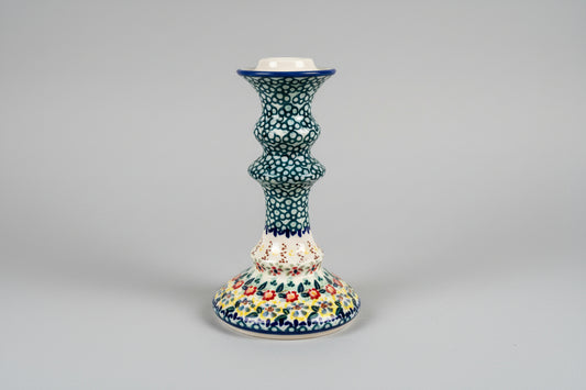 Decorative ceramic candle holder on a lace tablecloth