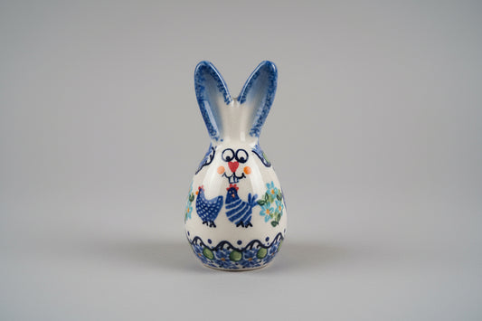 Ceramic fish-shaped object with blue and white design on a textured surface