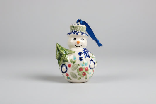 Decorative ceramic item shaped like a bow with floral patterns on a textured surface