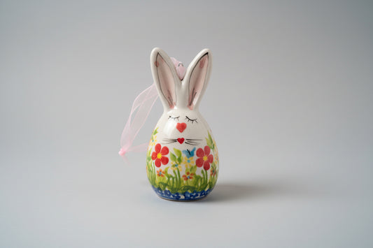 Ceramic bunny with floral design on a textured surface