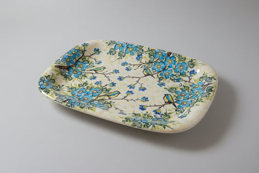 Decorative stone with floral and bird design on a lace doily