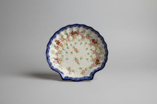 Decorative plate with floral and animal pattern on a lace tablecloth