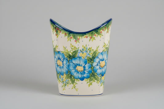 Decorative ceramic vase with blue floral design on a lace tablecloth